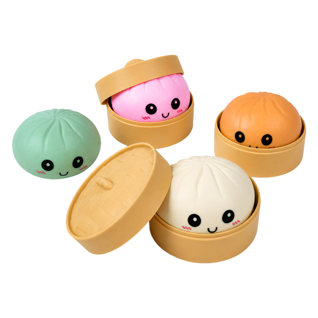 The Baozi Squishy with Steamer Display Box features four colorful, round dumpling squishies with adorable smiling faces—green, pink and orange in open steamers, and a white one next to a steamer lid.